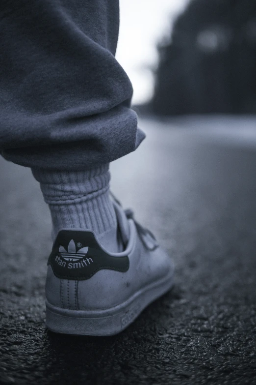 close up view of an adidas sneaker on the ground