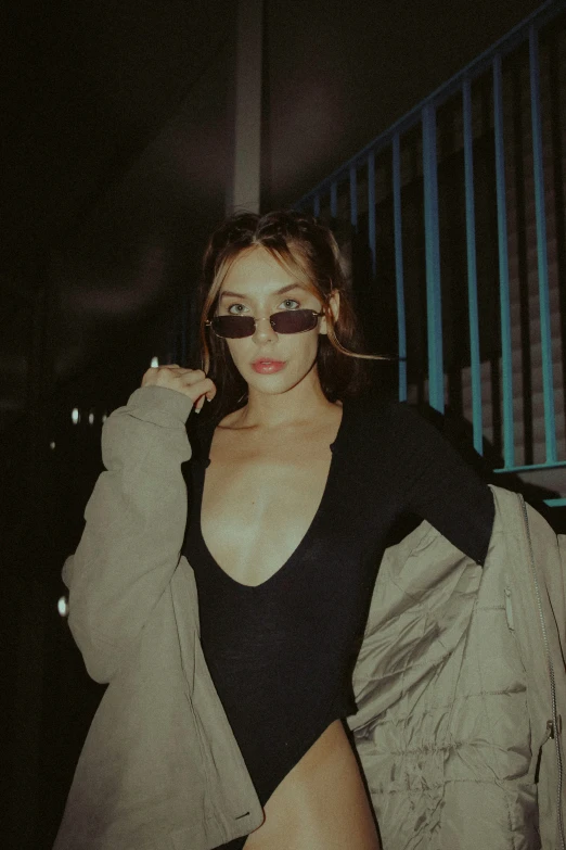 a woman wearing a black bikini top and sunglasses