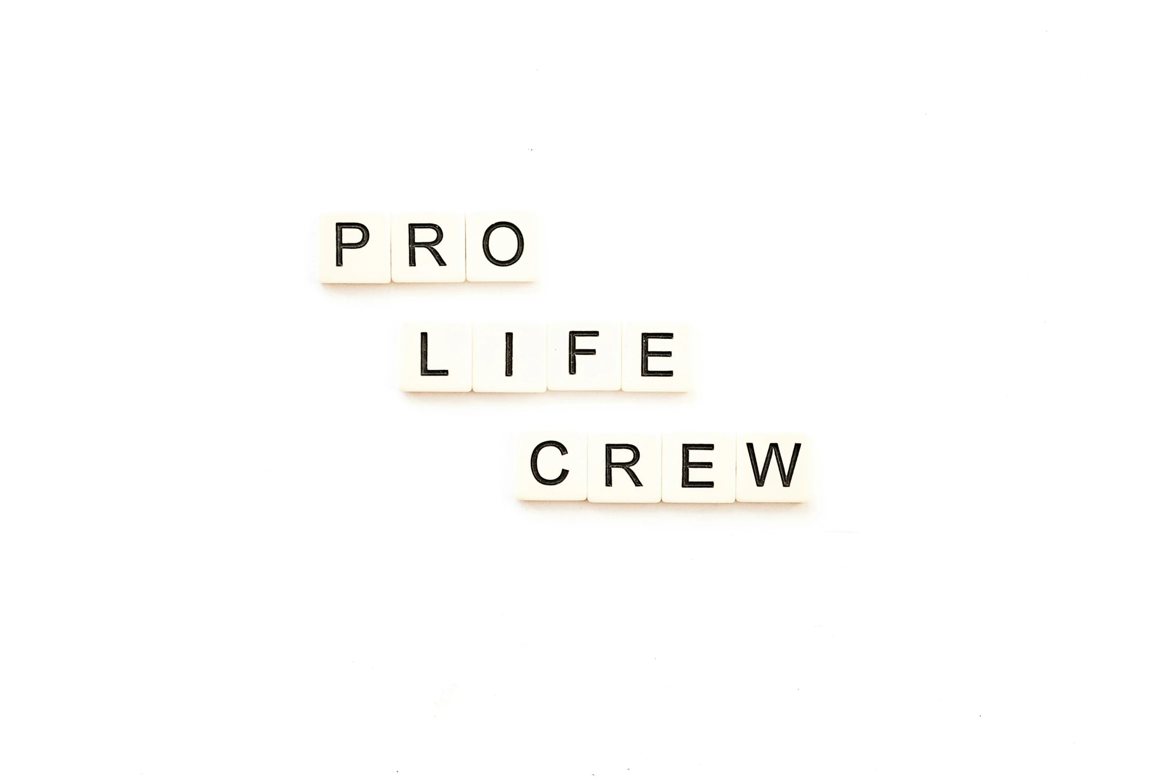 scrabble letters spelling pro life crew over white background