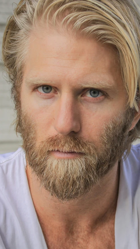 a young man with blond hair and a beard