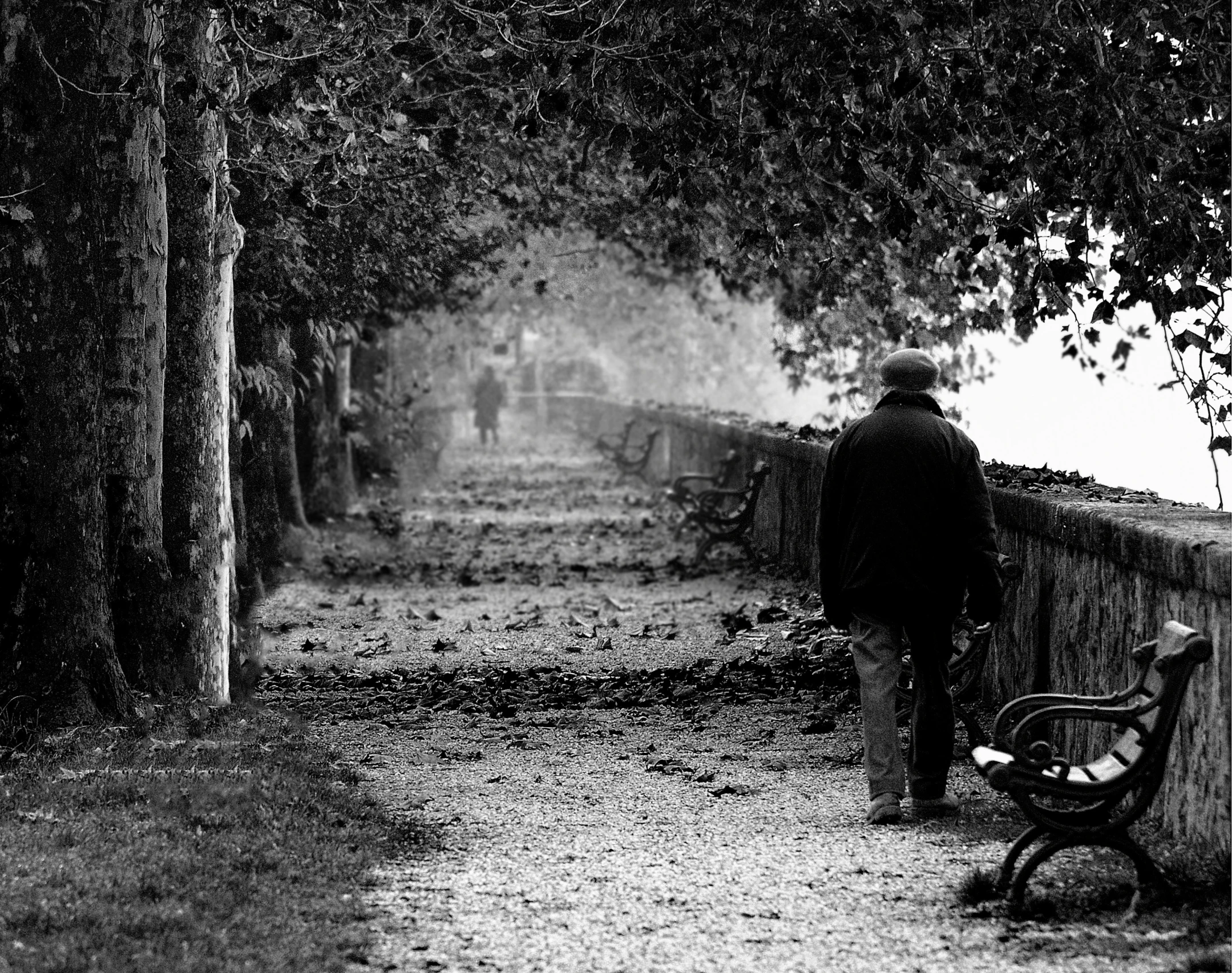 a man and his baby sit together on a bench in the dark