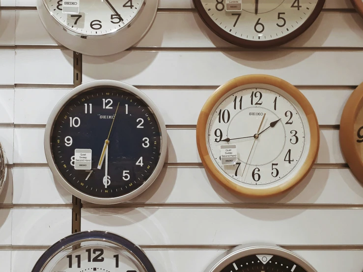 a number of clocks are hanging up on the wall