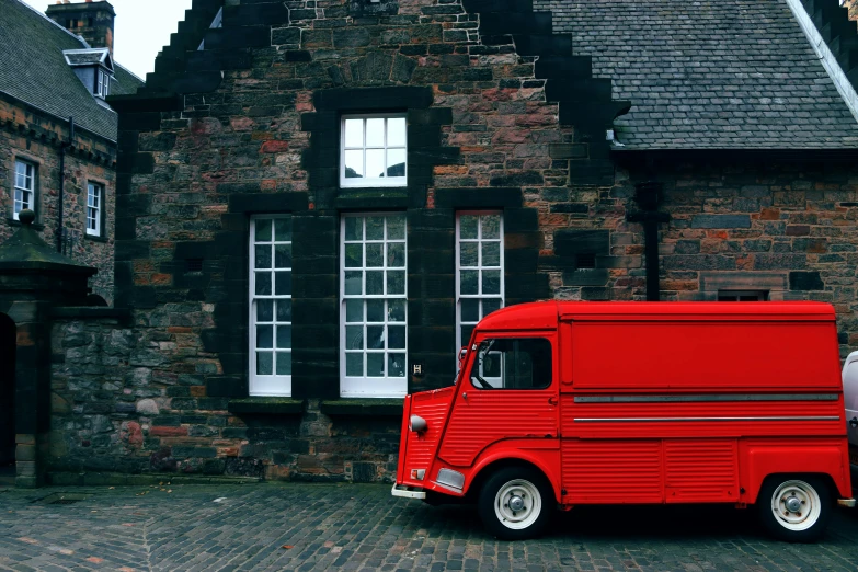 a red truck parked in front of a building