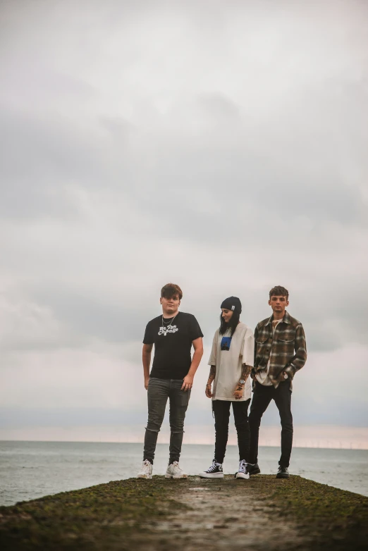 three men standing on top of an island