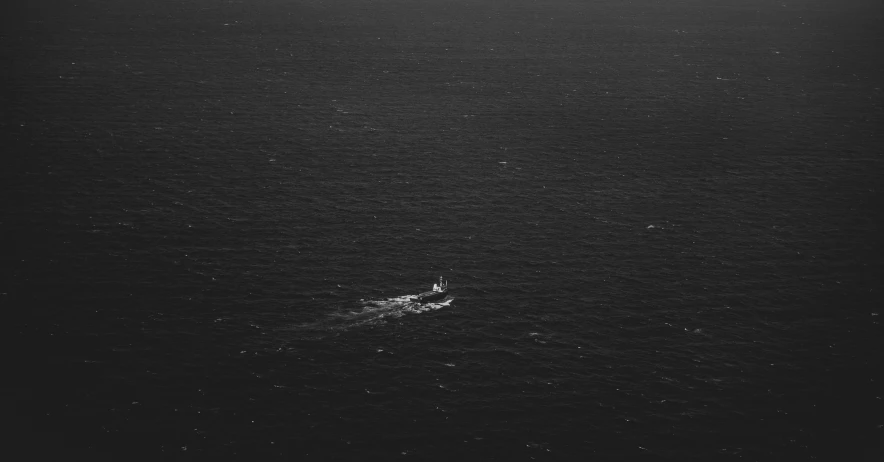 black and white po of an ocean with a boat