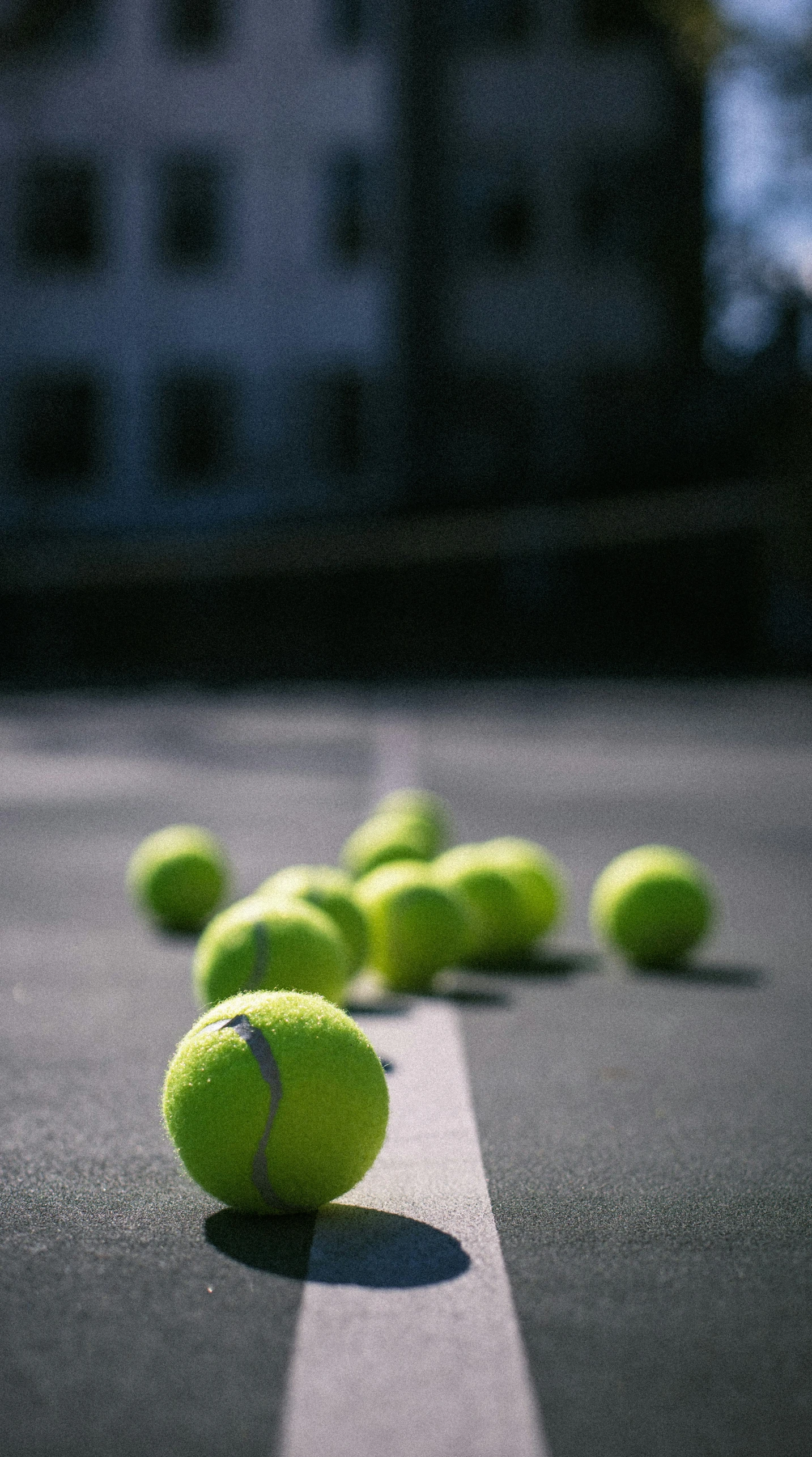 a group of tennis balls laying on the ground