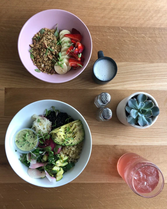 two bowls are full of food on the table