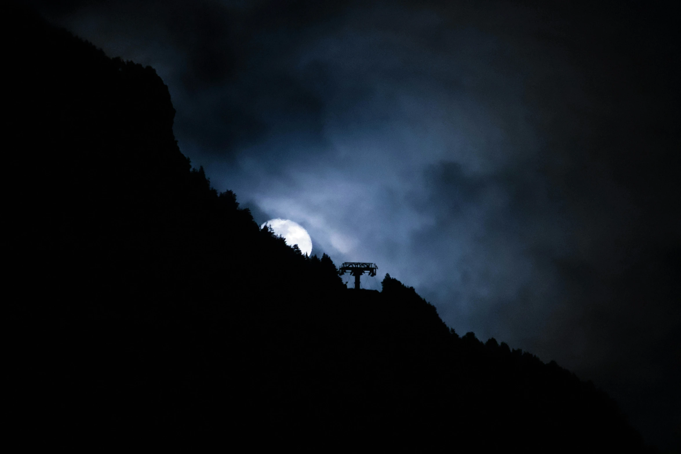 a black and white po of a hill at night