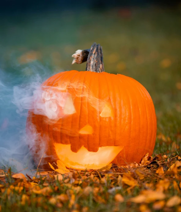 a pumpkin is smoking in a yard