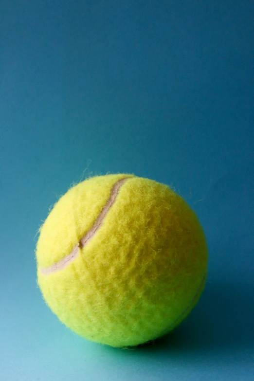 there is a ball on the top of the tennis court