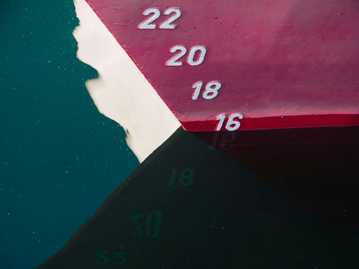 the side of a boat with its waken up and numbers on it