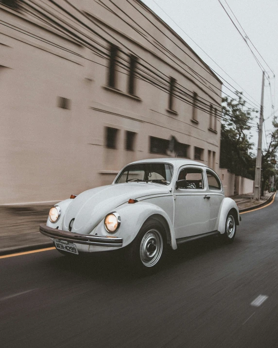 an old vw bug driving in the street