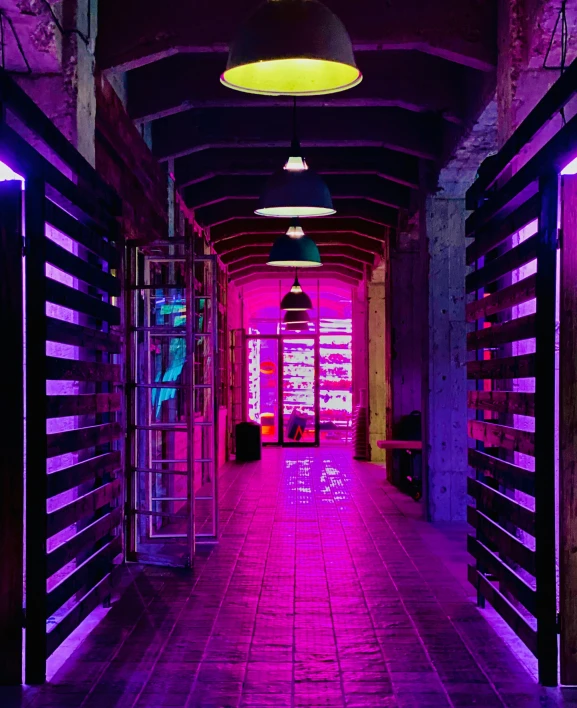 an empty hallway with multiple lights in the ceiling