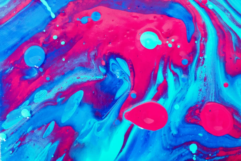 the fluid art with colors that are mixing together