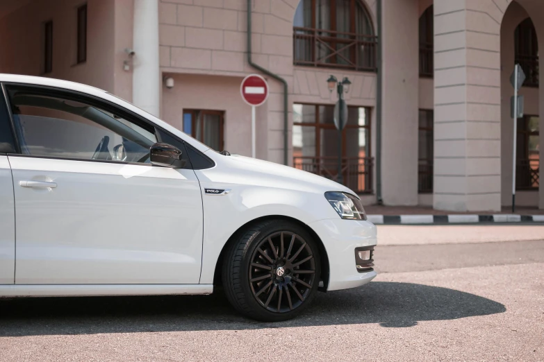 white volkswagen in front of an apartment building