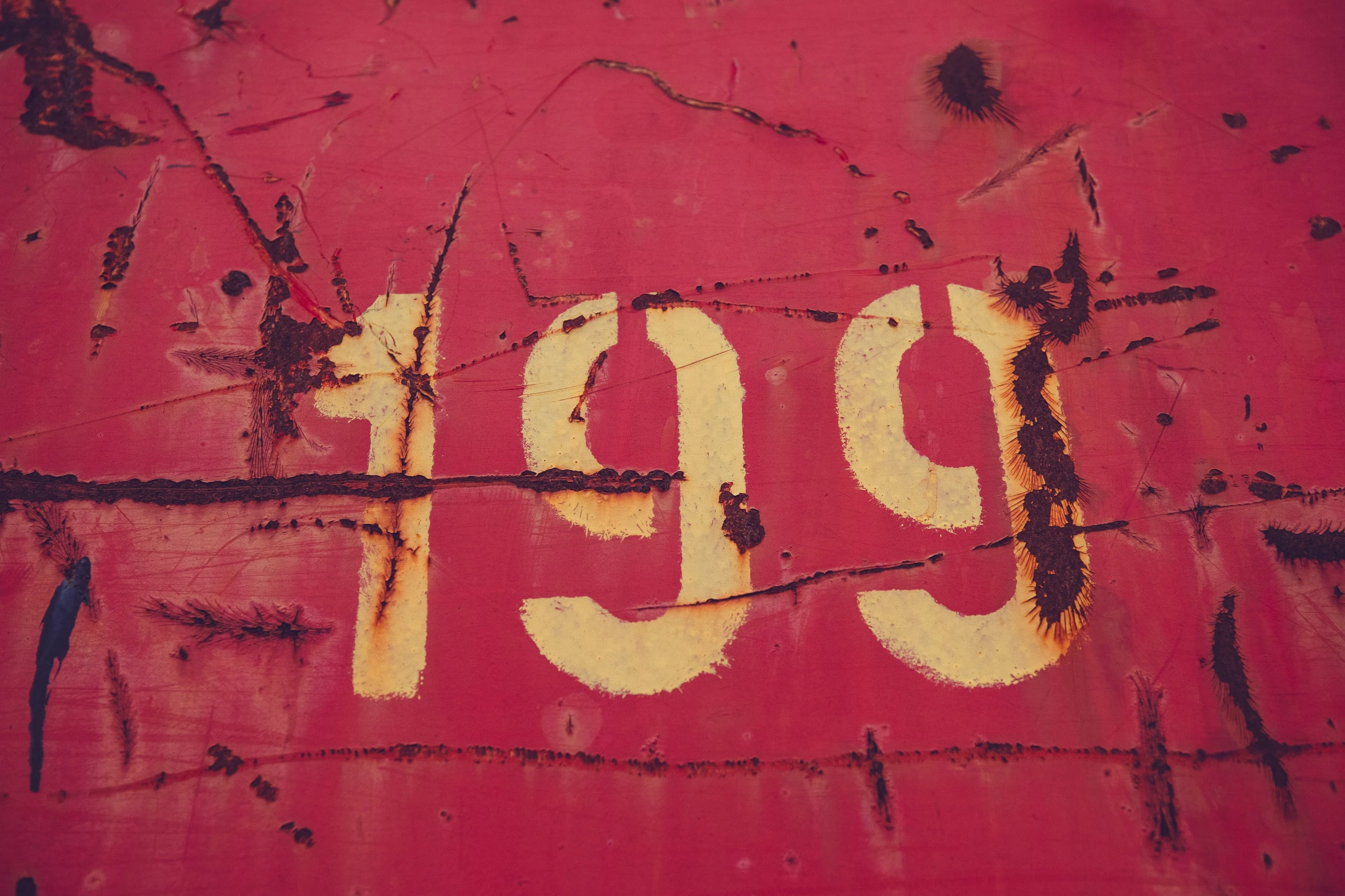 red graffiti that has the number 999 painted on it
