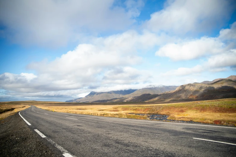 an empty road through the mountain landscape