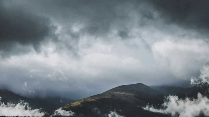 storm clouds over mountains, over a treeline