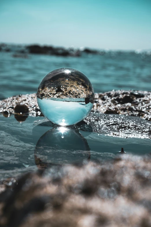 a ball sitting in the middle of some water