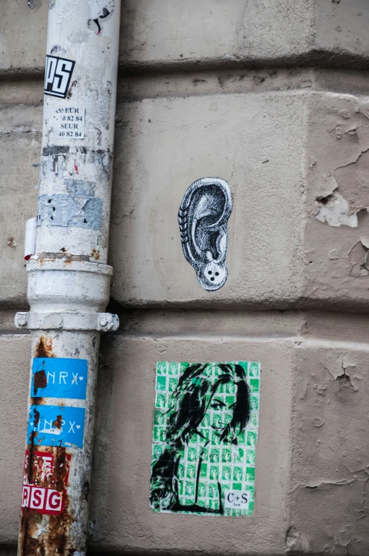 several stickers are attached to the side of a building