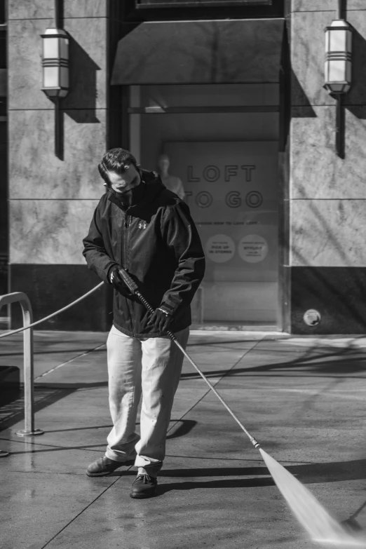 black and white image of a man using a mop