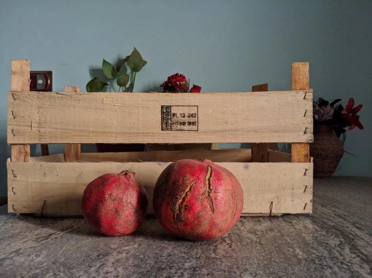 a wooden crate filled with ripe fruits and vegetables