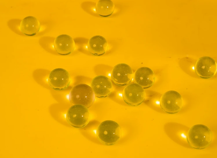 a yellow surface is covered in several soap bubbles