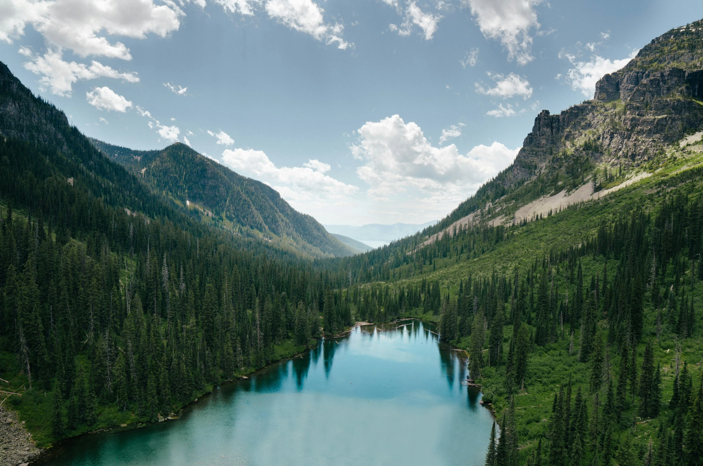 the top of a mountain next to a lake