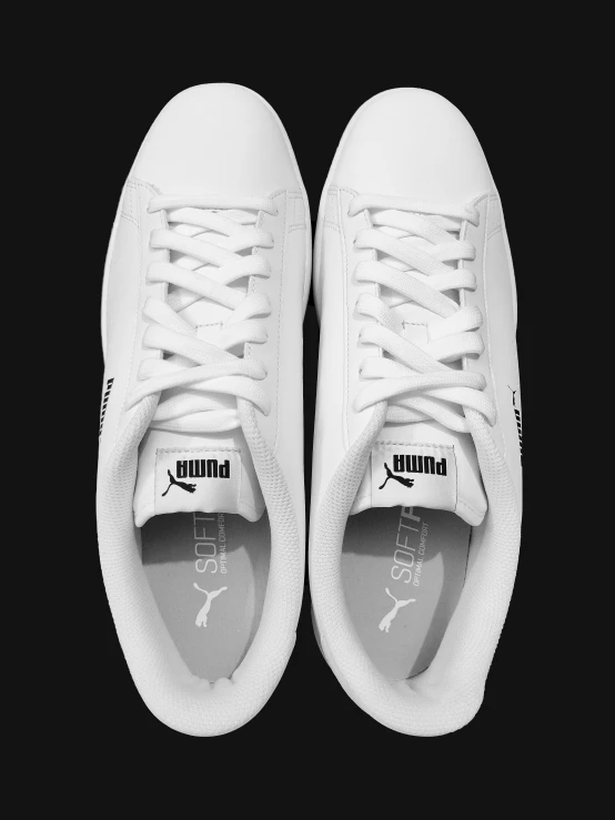 a pair of white sneakers with a black sole