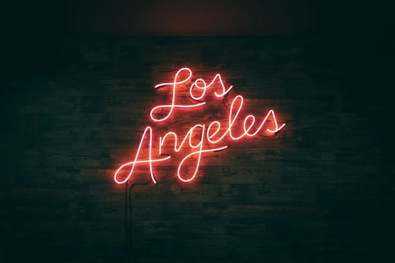 neon sign that says los angeles on a brick wall