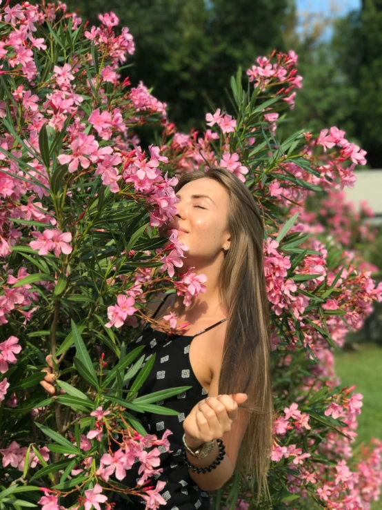 the girl is blowing on the wind from the flowers