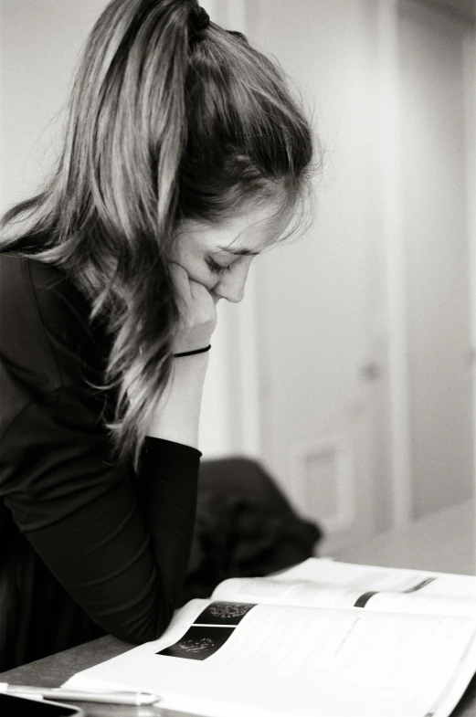 a black and white po of a woman sitting at a table