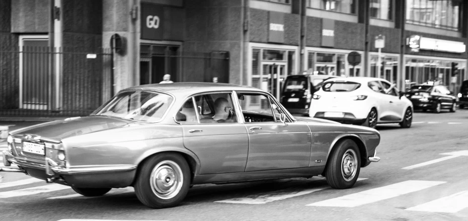 a line of cars stopped at the curb near buildings