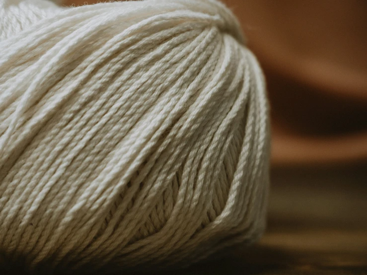 a white skein of yarn is laying down