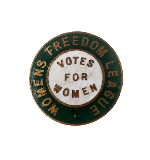 a green and white pin that reads women's freedom vote for women