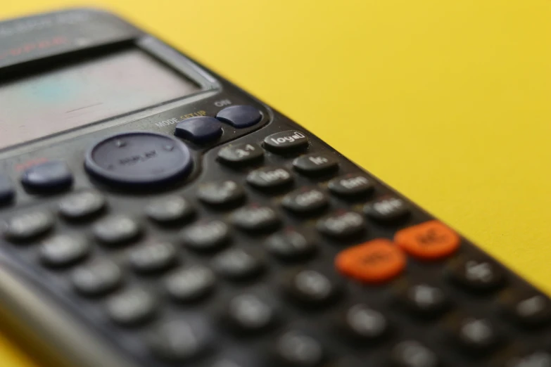 closeup s of a calculator on a yellow background