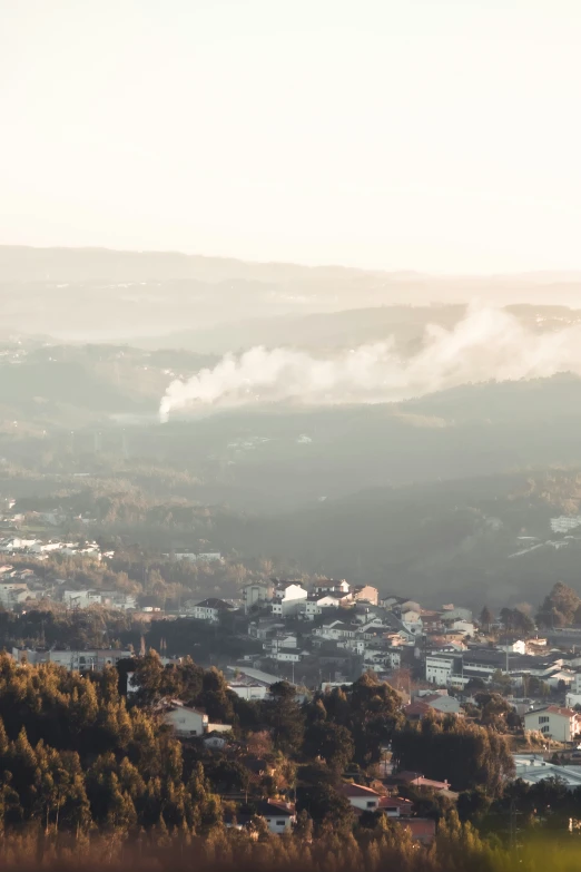 a city sits in the distance over a hill