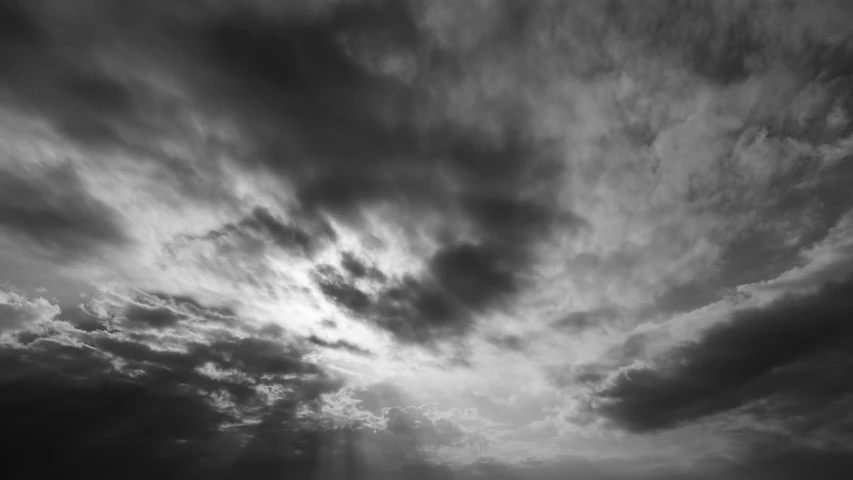 a large black and white cloudy sky with clouds