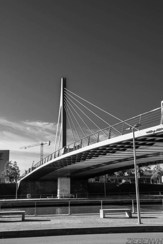 the black and white po shows a bridge that is built on top of land