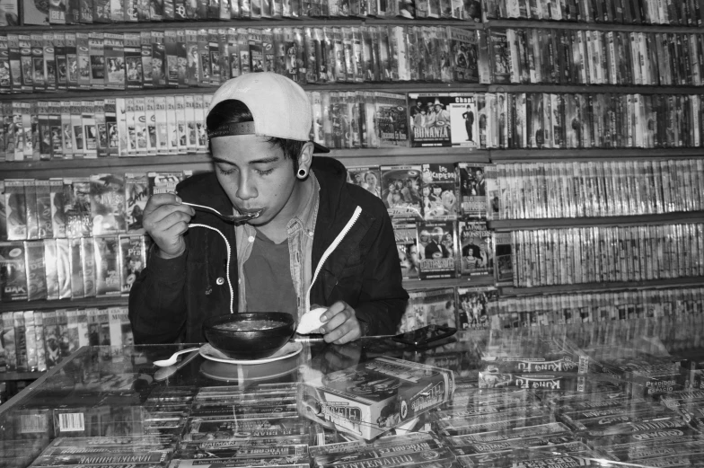 a man eating cereal on top of a table