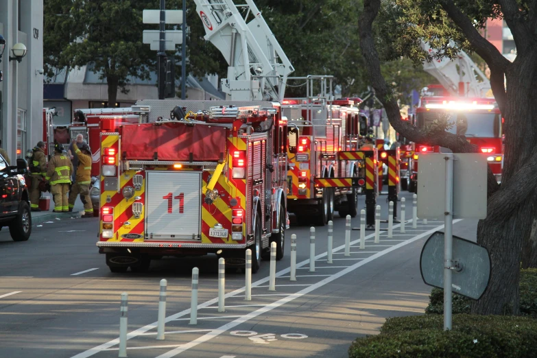 a fire truck and several emergency vehicles parked along the curb