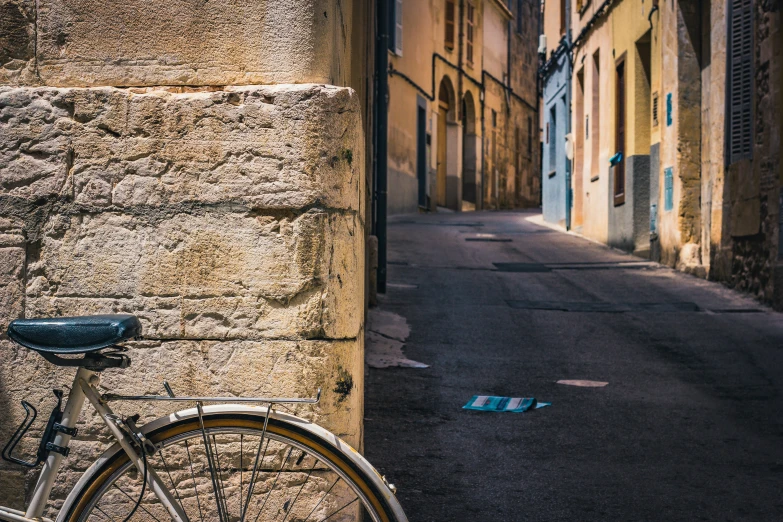 the bicycle is parked next to the building