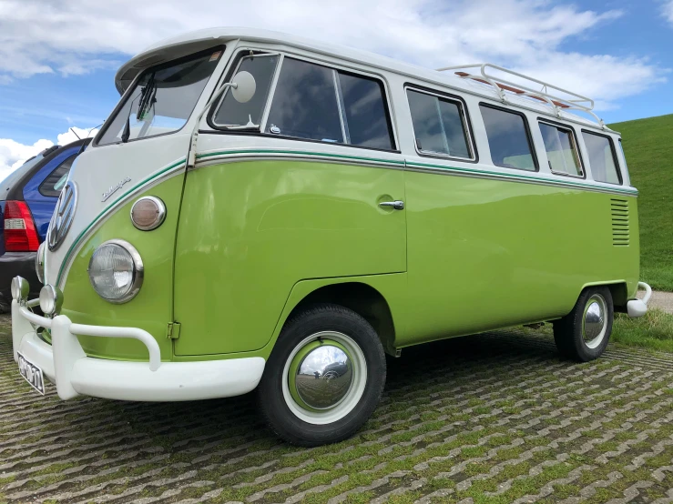 a lime green vw van parked in front of a mountain