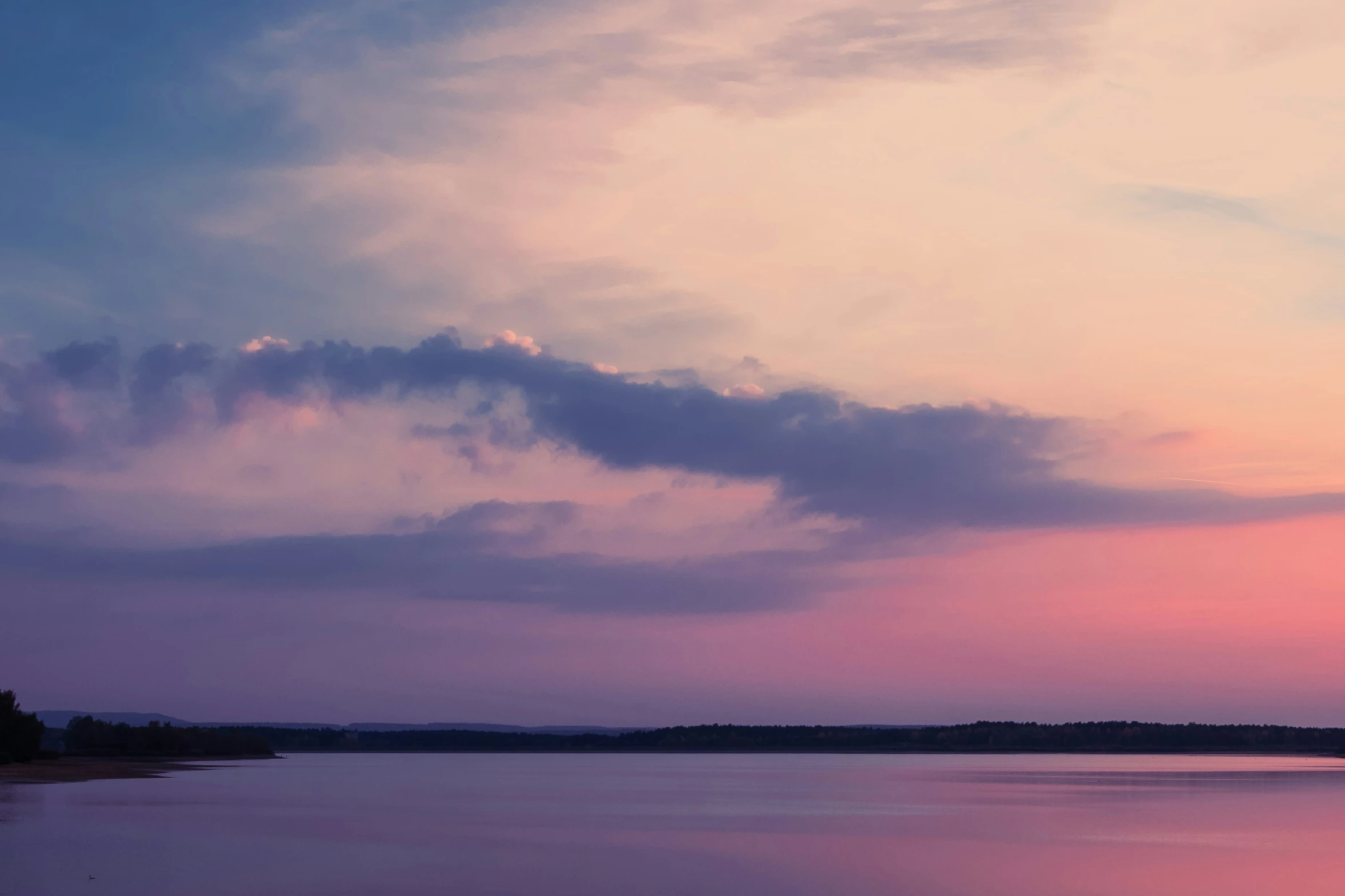 a po taken from the beach of a lake that is very pink