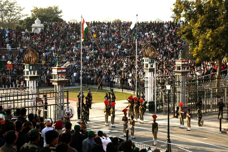 several people are watching horses and riders in a parade