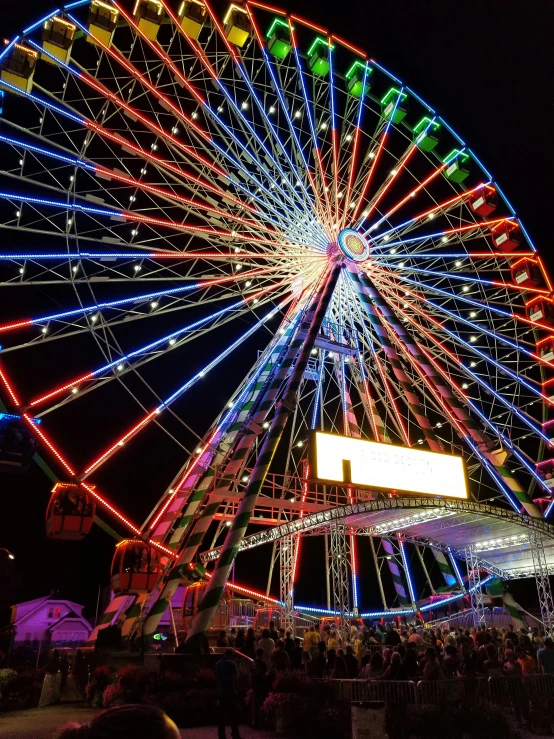 a colorful fireworks wheel in the night sky