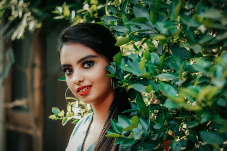 an woman with red lipstick is looking into the camera