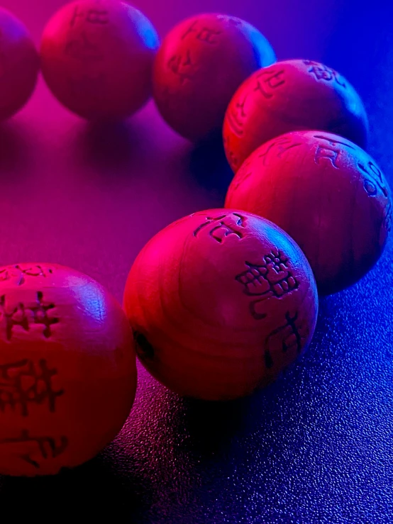 a line of plastic balls with writing on them