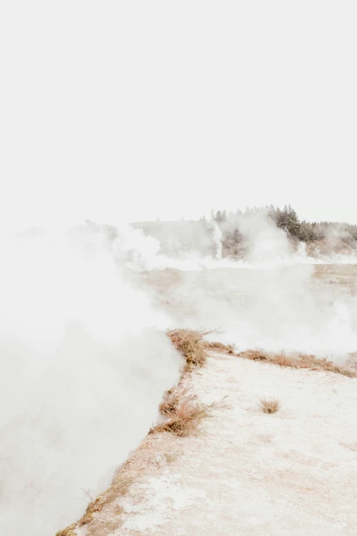 a steam engine going down some rocks by the water