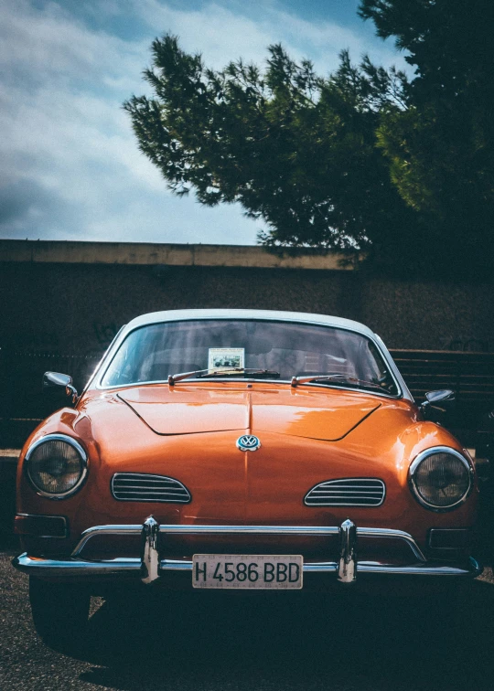 an orange classic car with a license plate